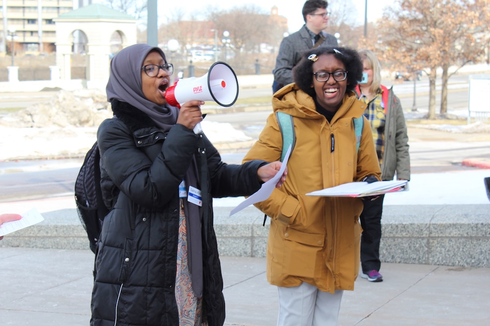 https://mnyouth.net/wp-content/uploads/2025/01/2020-02-24-MYC-members-gather-young-people-at-the-Capitol-with-bullhorns-happy.jpg