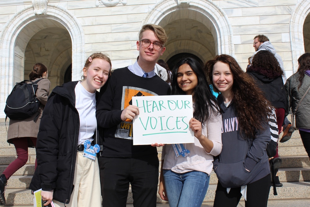 https://mnyouth.net/wp-content/uploads/2025/01/2020-02-25-MYC-members-pose-with-a-sign-that-says-Hear-Our-Voices-at-Youth-Day-at-the-Capitol-YDAC.jpg